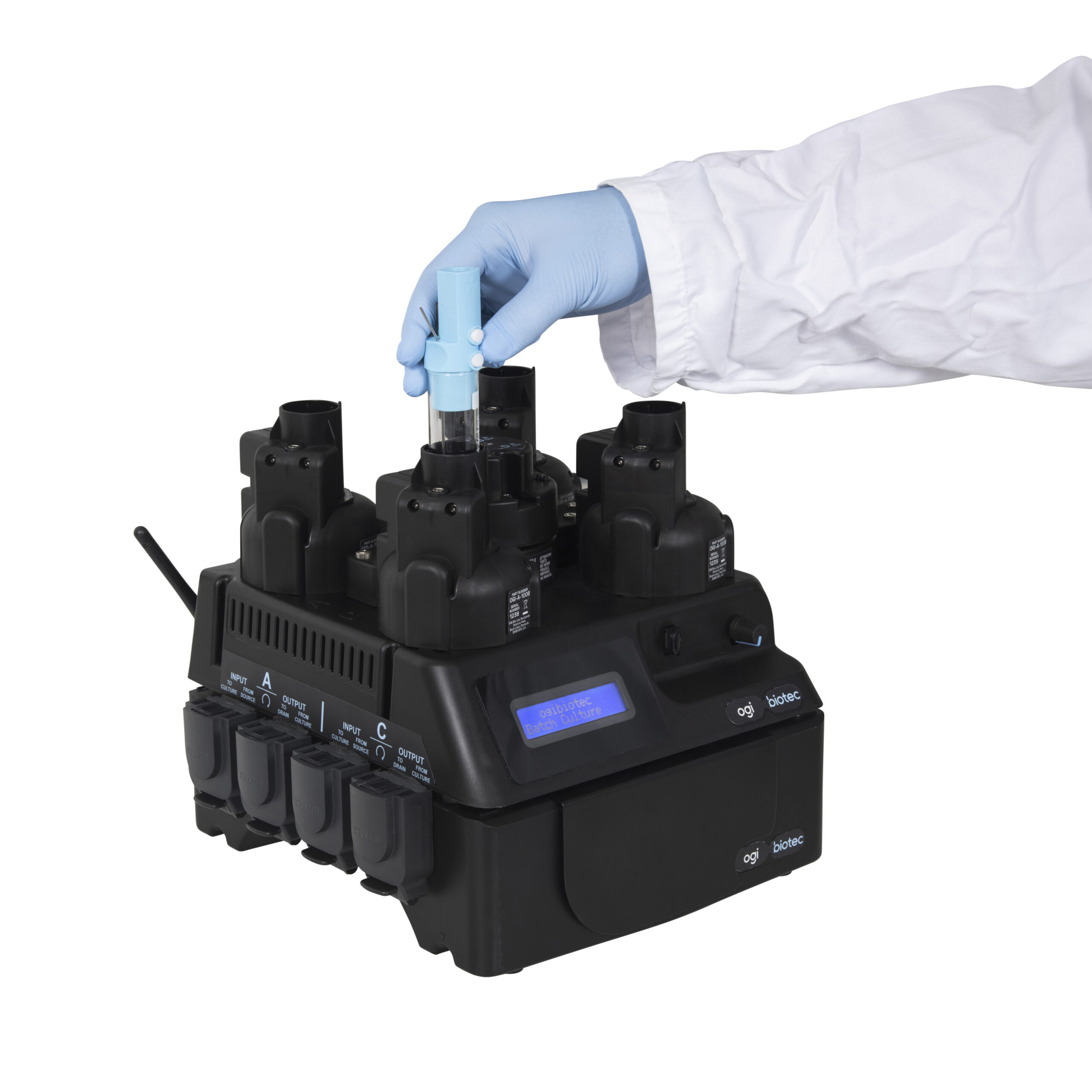 OGI3 Base unit powered on with a liquid control module connected to it. A hand is shown inserting a culture flask into reactor C